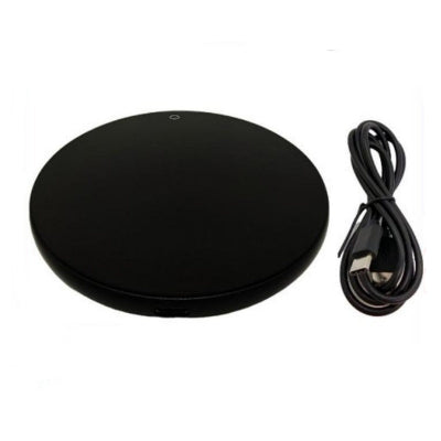 Black round wireless charging pad with USB cable on a white background