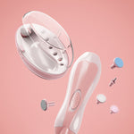 White handheld device with attachments on a pink background