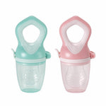 Two baby food feeders, one green and one pink, on a white background.