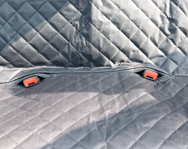Gray quilted car mat with red clips on a textured surface of Dog Car Seat Cover