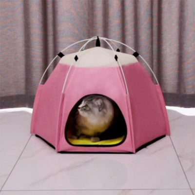 Pink pet tent with a small animal peeking out on a tiled floor.