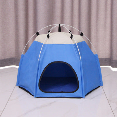 Blue pet tent with a white top on a tiled floor.