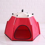 Red pet tent with white top on a light gray background