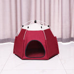 Red pet tent with white top on a light gray floor and curtain background
