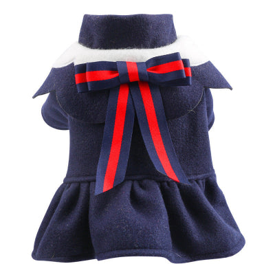 Navy blue pet dress with a red bow on a white background