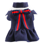 Navy blue pet dress with a red bow on a white background