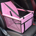 Pink pet car seat with straps on a car seat