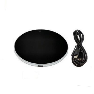 Black round heating pad with a power cord on a white background
