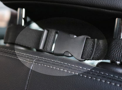 Close-up of a car seat belt buckle and strap in a vehicle interior.