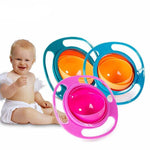 Baby with colorful baby bowls on a white background
