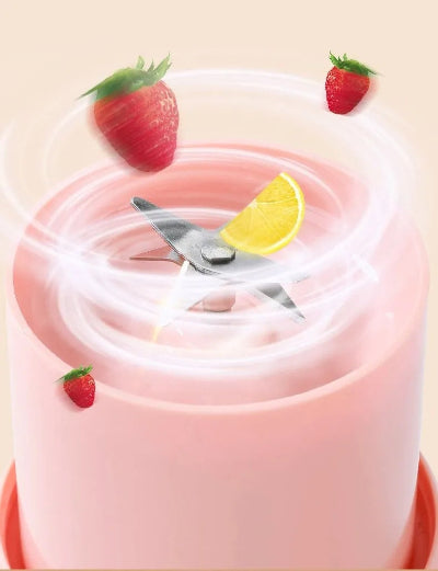 Pink smoothie with strawberries and a lemon wedge on a light yellow background