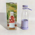 Glass bottle with purple lid and base next to its packaging featuring strawberries.