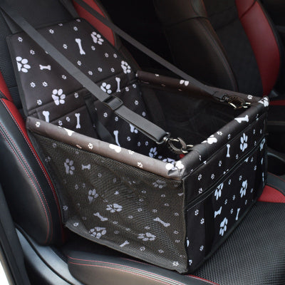 Pet carrier with paw and bone pattern on a car seat