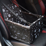Pet carrier with paw and bone pattern on a car seat