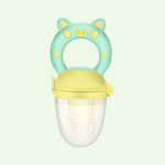 Children's fruit feeder with pig design on a light green background