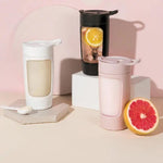 Three portable coffee makers on a pink background with fruits.