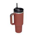 Red travel mug with a black lid and straw on a white background