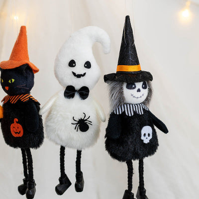 Three Halloween-themed plush toys: a black cat, a ghost, and a witch, on a light background.