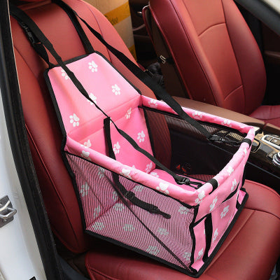 Pink pet seat cover with paw prints on a car seat