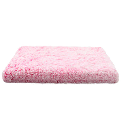Pink fluffy cushion on a white background