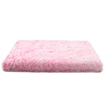 Pink fluffy cushion on a white background