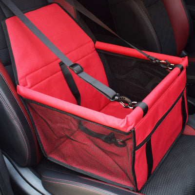 Red pet seat cover with straps on a car seat