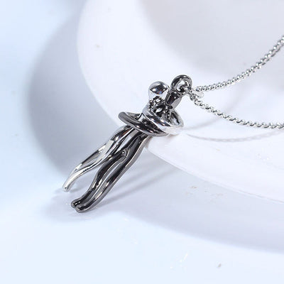 Silver pendant of a person on a white background