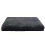 Dark gray fluffy cushion on a white background