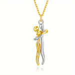 Two-tone gold and silver pendant on a white background