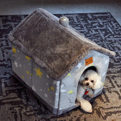 Dog peeking out from a gray pet house with star patterns on a textured floor.