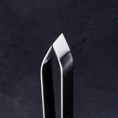 Metallic tool or blade on a dark textured background