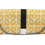 Yellow and white patterned bag with a black strap on a white background