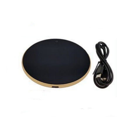 Black and gold wireless charging pad with a cable on a white background