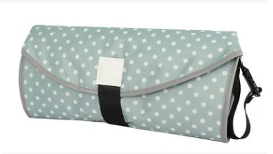 Foldable picnic mat with polka dot pattern on a white background