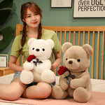 Woman holding two teddy bears, one white and one brown, in a bedroom setting.