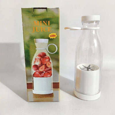 Mini juice maker with packaging on a white background