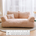 Beige plush sofa with size chart in a room with white curtains