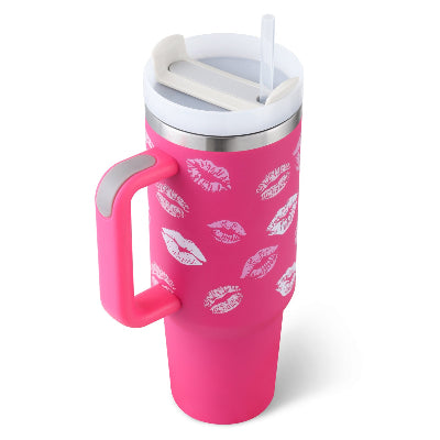 Pink tumbler with white lip prints and a handle on a white background