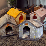 Collection of pet houses in various colors and designs on a carpeted floor.