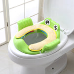 Green frog-shaped toilet seat cover on a white toilet