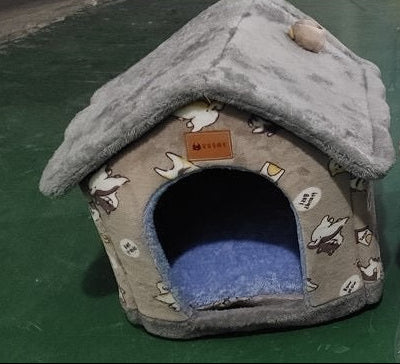 Gray pet house with cartoon designs on a green surface