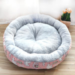 Round pet bed with plush interior and colorful exterior on a wooden floor.