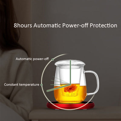 Glass teapot with hot liquid on a red base, featuring text about automatic power-off protection.