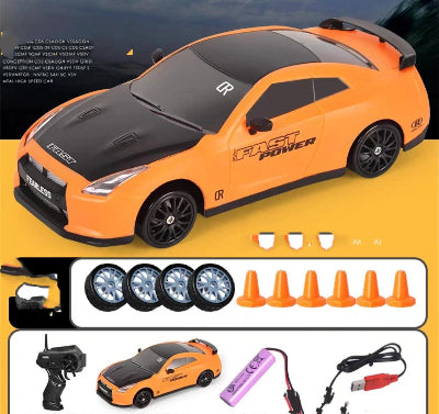 Orange toy car with black roof on a yellow background, accompanied by remote control, batteries, and cones.