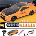 Orange toy car with black roof on a yellow background, accompanied by remote control, batteries, and cones.