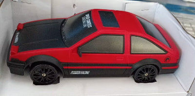 Red toy car with black accents on a white background