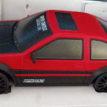 Red toy car with black accents on a white background