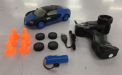Toy car with remote control, battery, and small obstacles on a white surface