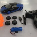 Toy car with remote control, battery, and small obstacles on a white surface