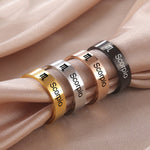 Four Scorpio zodiac sign rings in different colors on a beige fabric background